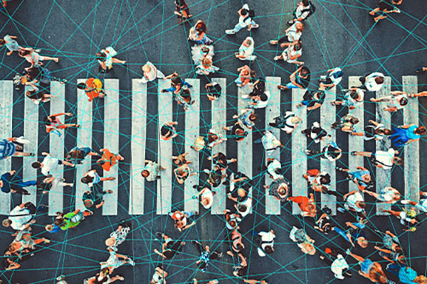 Aerial view of people walking on a pedestrian crosswalk