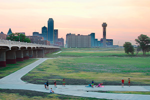 People working out in front of the Dallas skyline