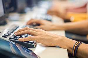 Hands at Computer Keyboard